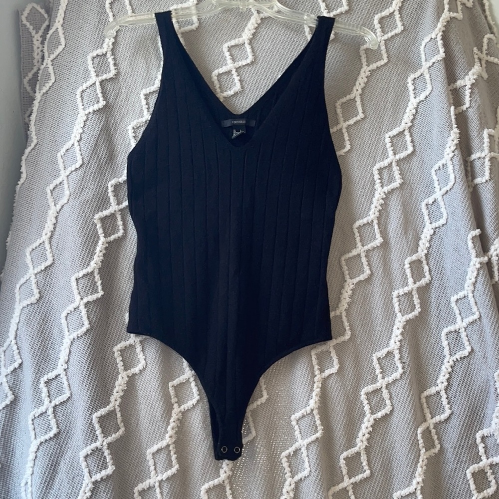 Worn but not buttoned
Forever 21 black sweater material thong bodysuit L